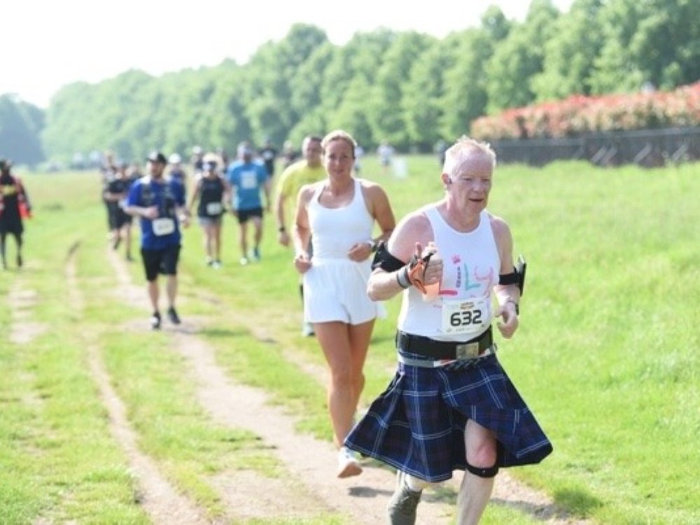 A man in a Lily top and kilt running along a track at the Edinburgh Marathon A man in a Lily top and kilt running along a track at the Edinburgh Marathon