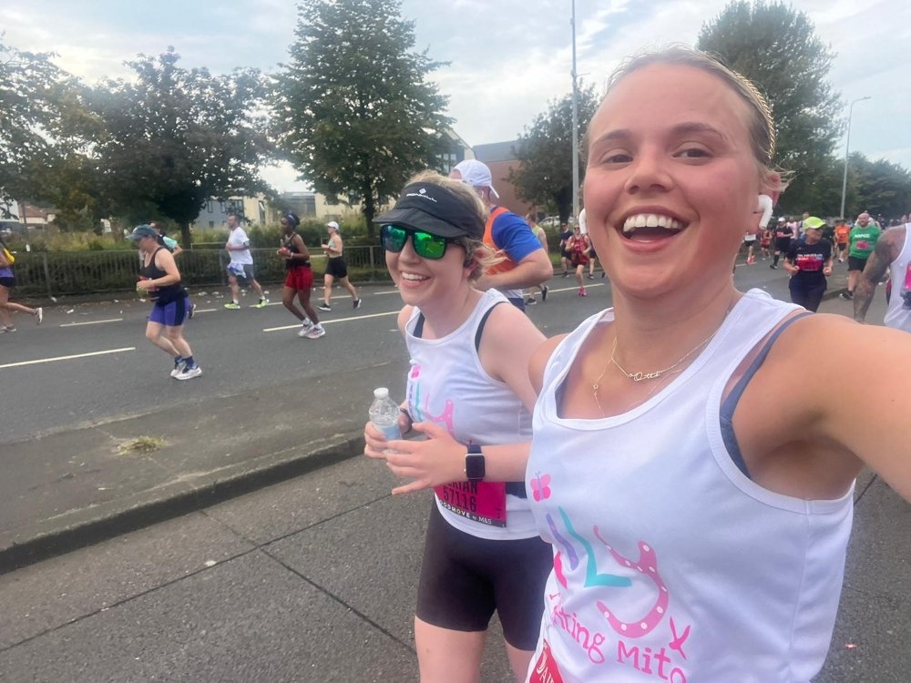 Two women in Lily tops running and smiling Two women in Lily tops running and smiling