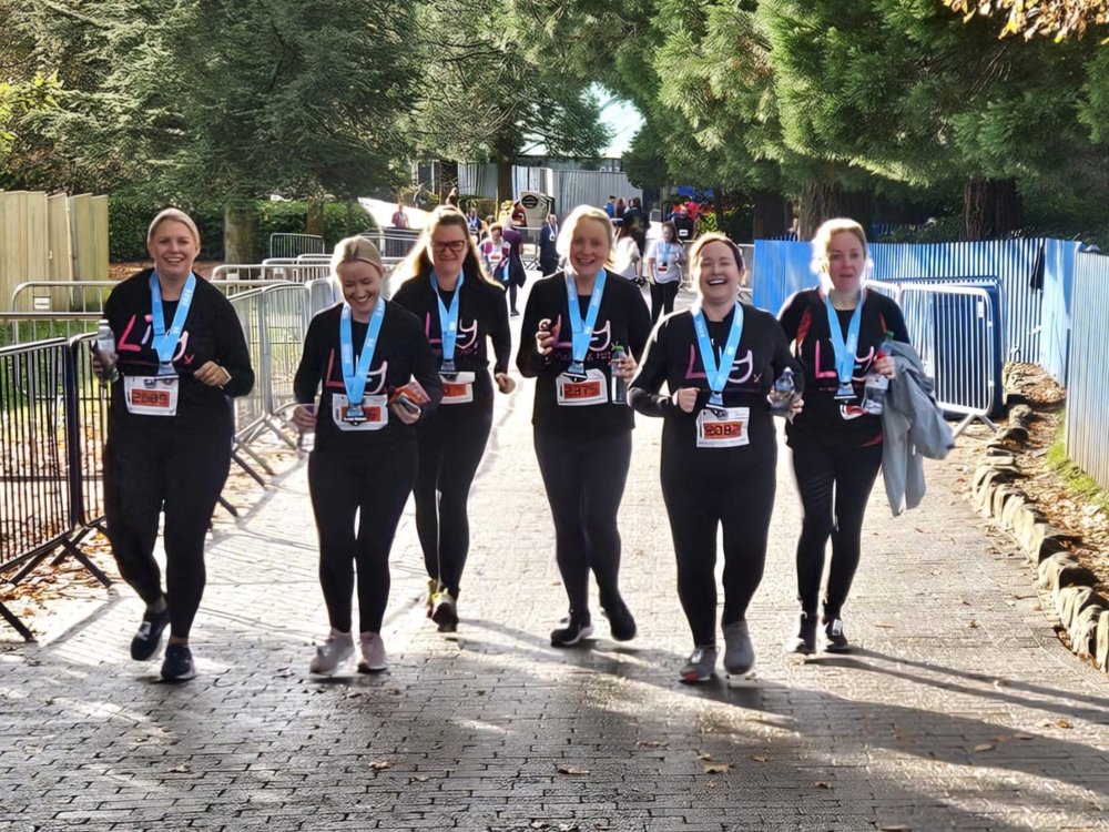 Run Alton Towers 5km 2025 - A group of ladies wearing Lily Foundation tops running at Alton Towers theme park