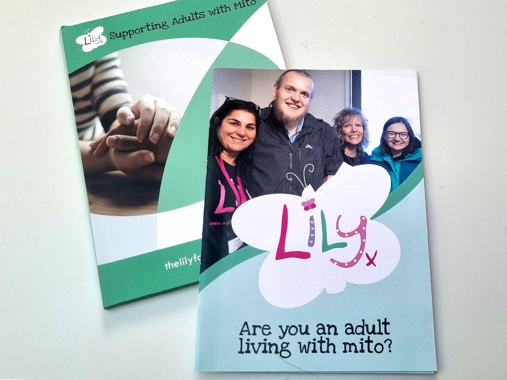 Green adult support pack with large white branded butterfly and a young adult with mito with his mum and 2 of the lily team