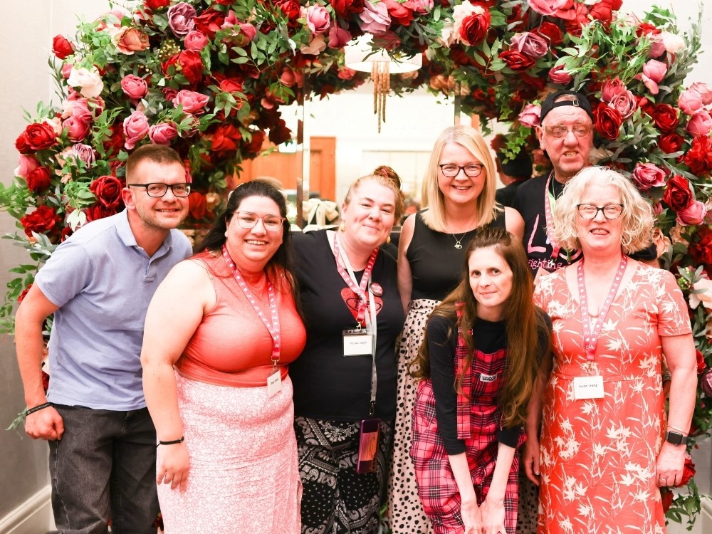 A group of adult mitochondrial disease patients standing together at a support weekend
