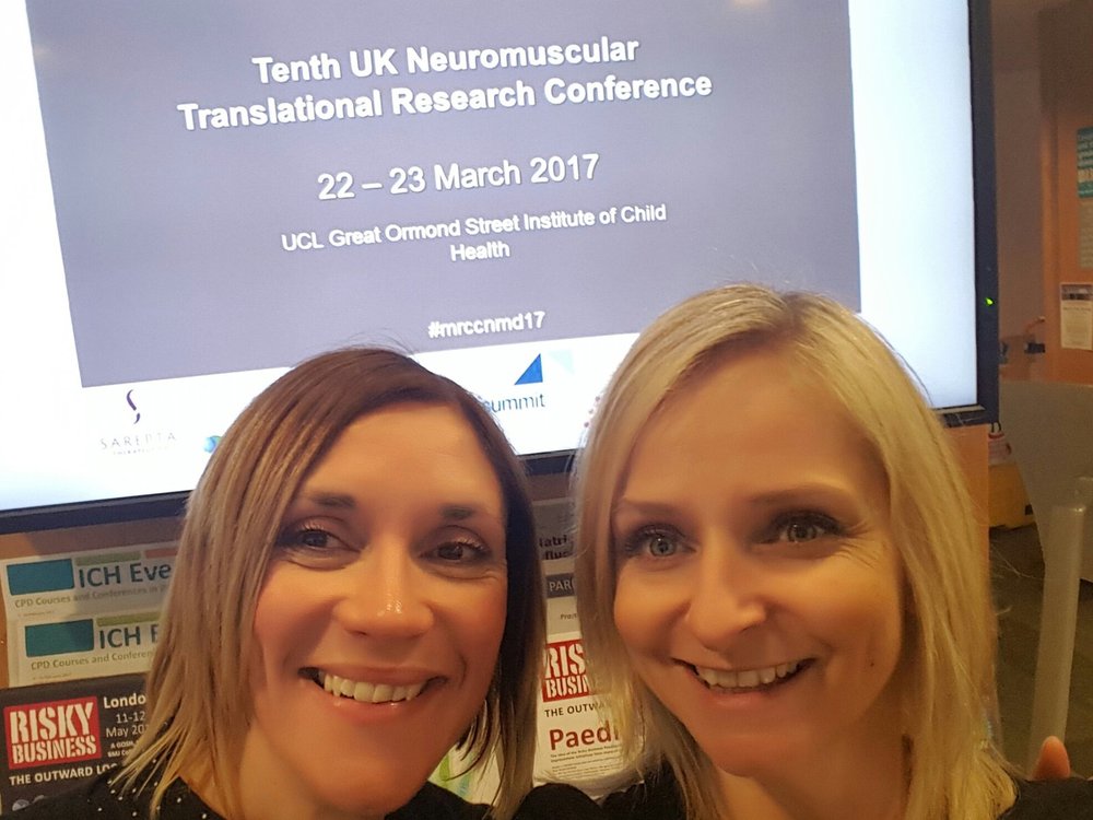 Head shot of two women with a presentation screen behind them