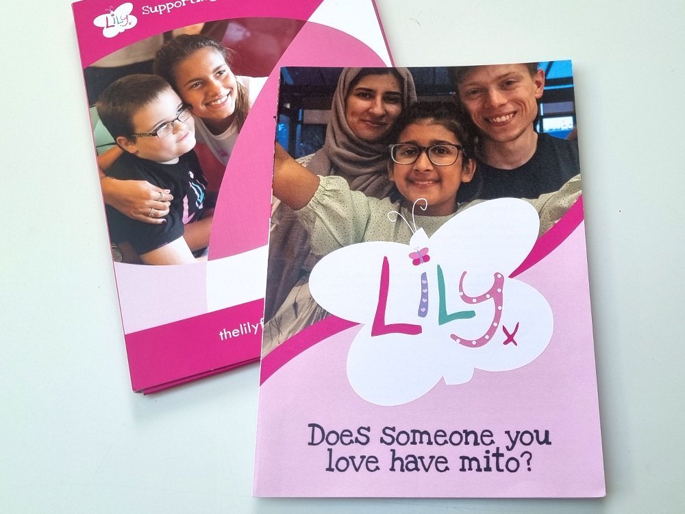 Pink family support pack with large white Lily branded butterfly and mito family with a Lily researcher