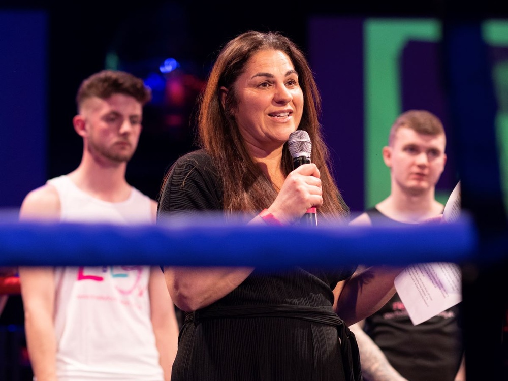 Lily CEO Liz addresses the crowd in the ring