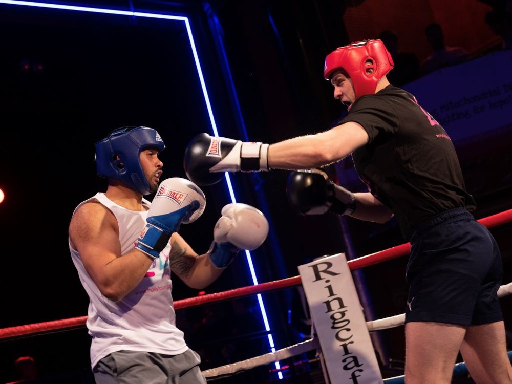 Two Lily boxers throwing punches at each other in the ring