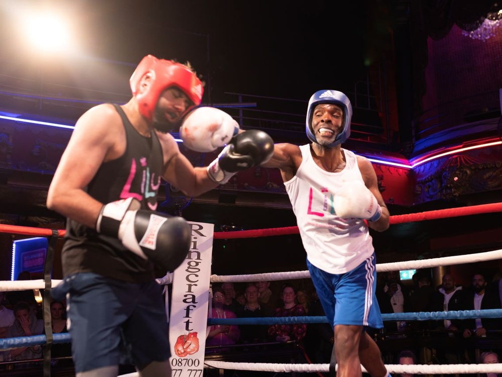 Two boxers in Lily vests throwing punches at one another