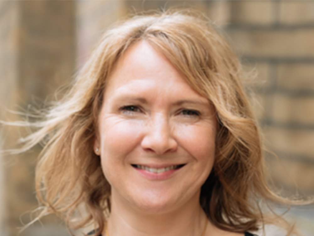 Smiling lady with blond shoulder length hair