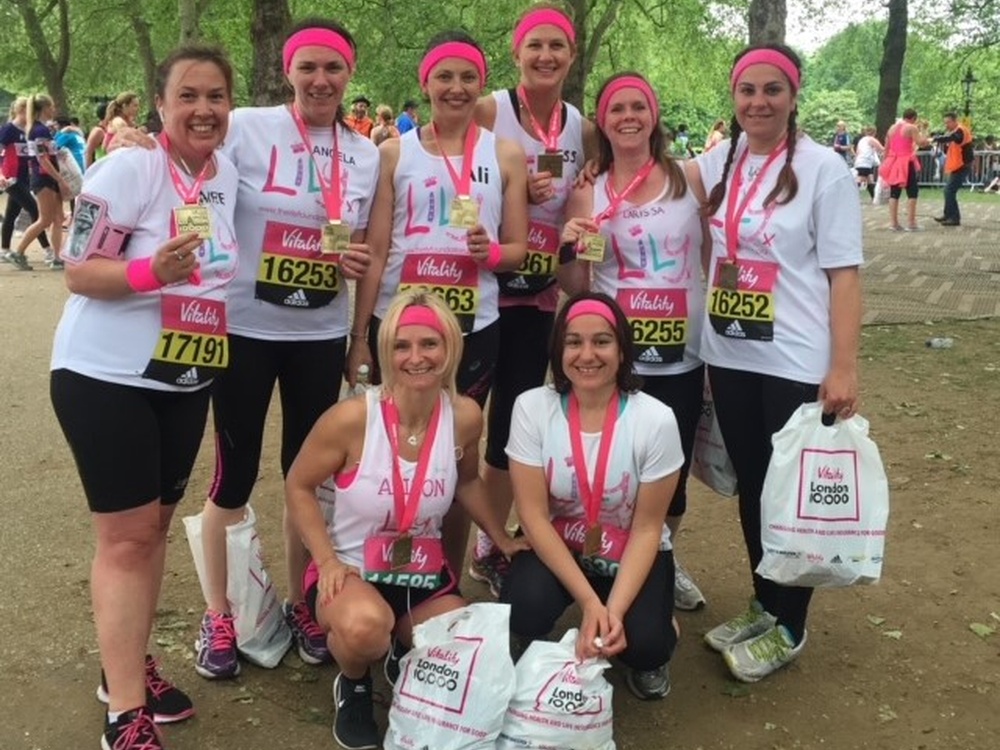 Team of "mito mum's" proudly holding up their vitality 10K running medals