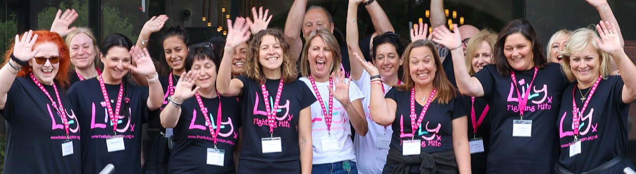 A group fo people in Lily Foundation tops standing and waving
