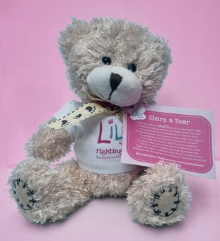 Cute teddy wearing a pink label