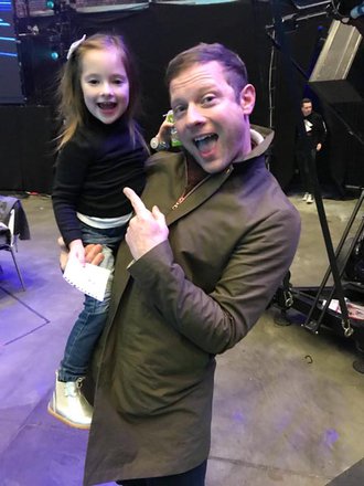 Dermot o'leary holds a little girl