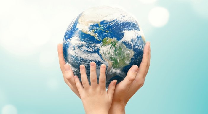 Hands holding up a globe in the air