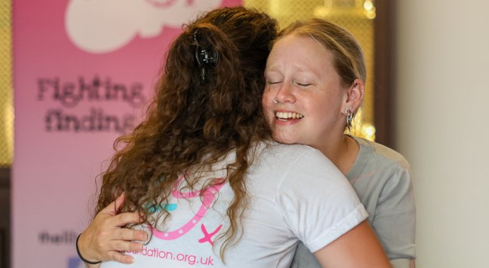 A lady with blonde hair hugging the CEO of The Lily Foundation, Liz Curtis