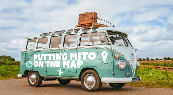 VW camper van with 'Putting mito on the map' logo on the side