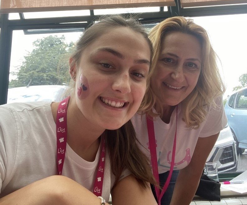 Close-up of Becca and her mum smiling at the Lily Family Weekend