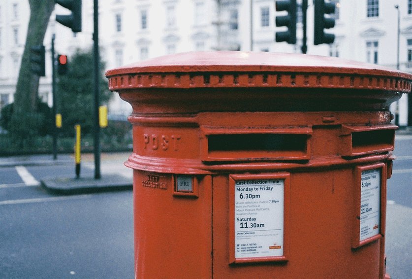 A red post box on a city street