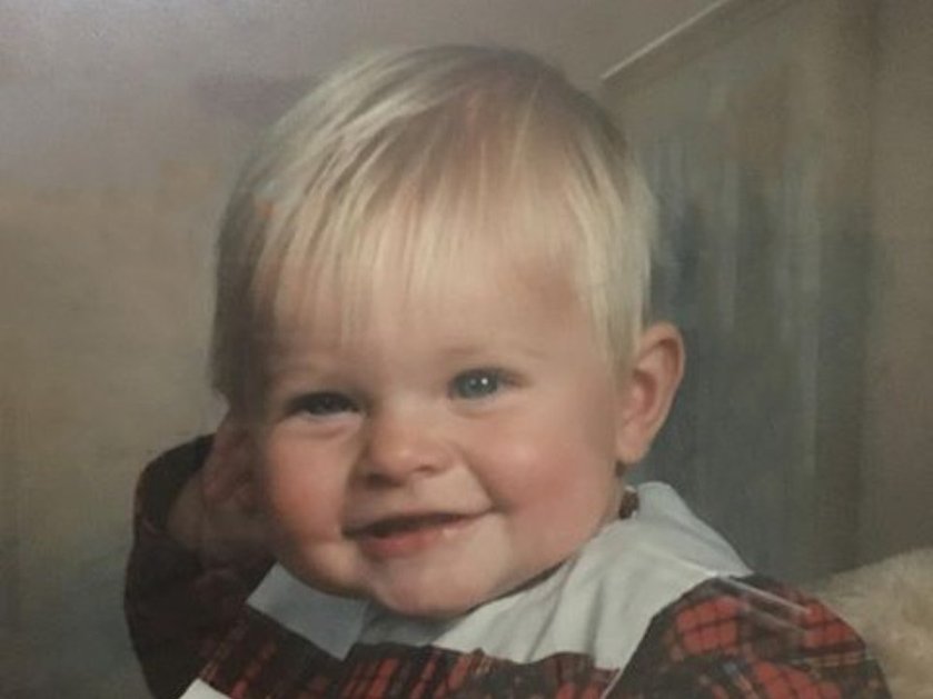 A young mito patient with blonde hair wearing a tartan dress