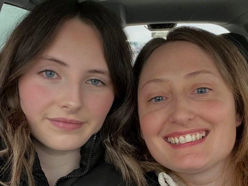 Close-up of a mother and daughter smiling
