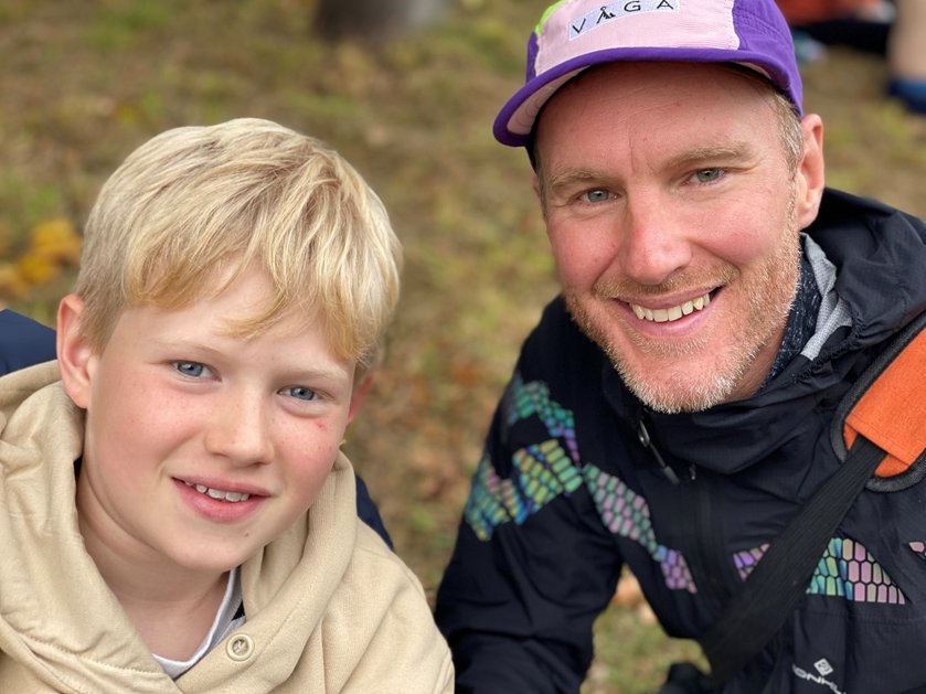 Mito patient Bill and his dad crouching together and smiling at the camera