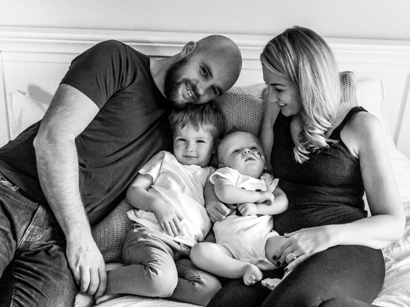 The family of baby Hector gathered around him on the sofa