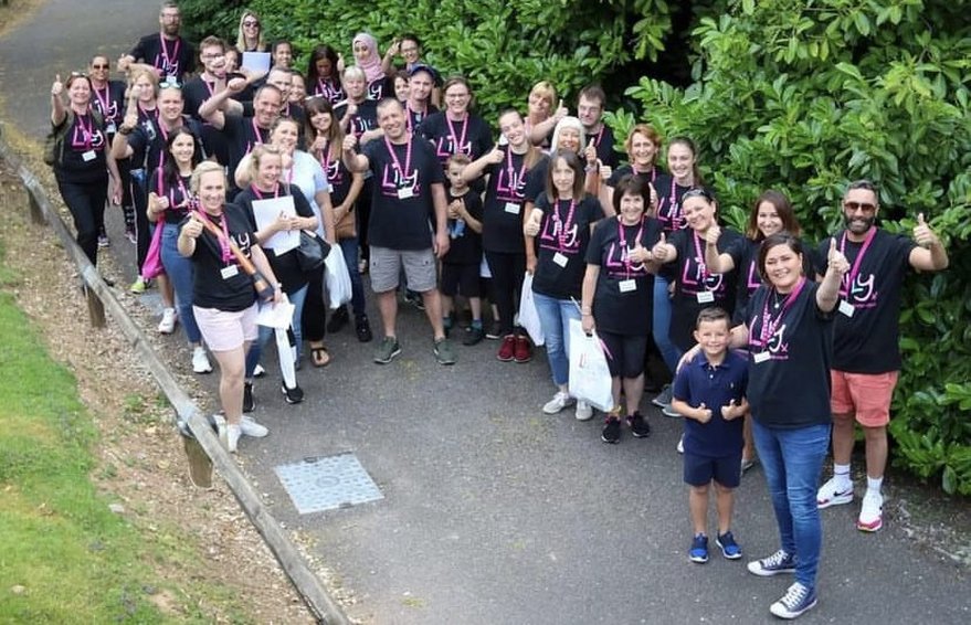 Large group of volunteers all wearing Lily t-shirts and giving a thumbs-up