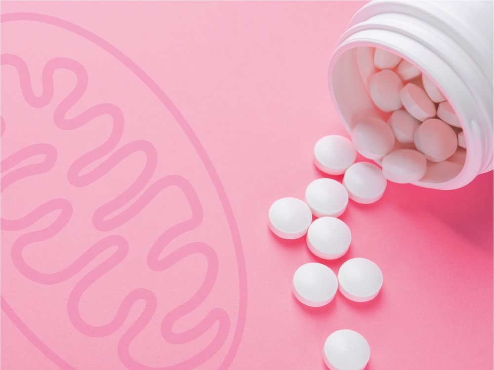 A bottle of white pills on its side with some spilling out onto a pink surface