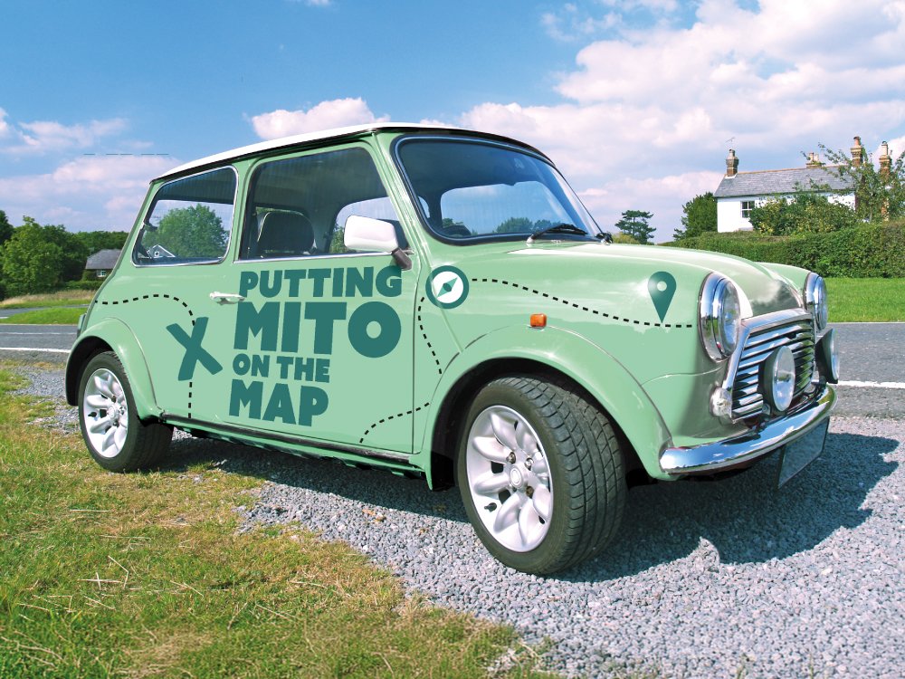 A green Mini with the words 'Putting mito on the map' on the door