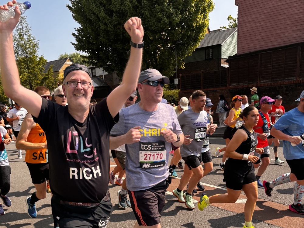 Lily runner Rich raising his hands at the London Marathon