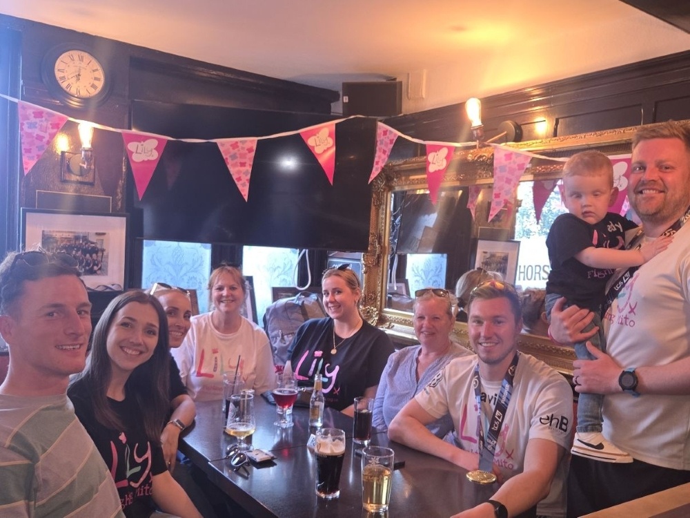 A group of Lily Foundation runners and supporters gathered around a table in a pub