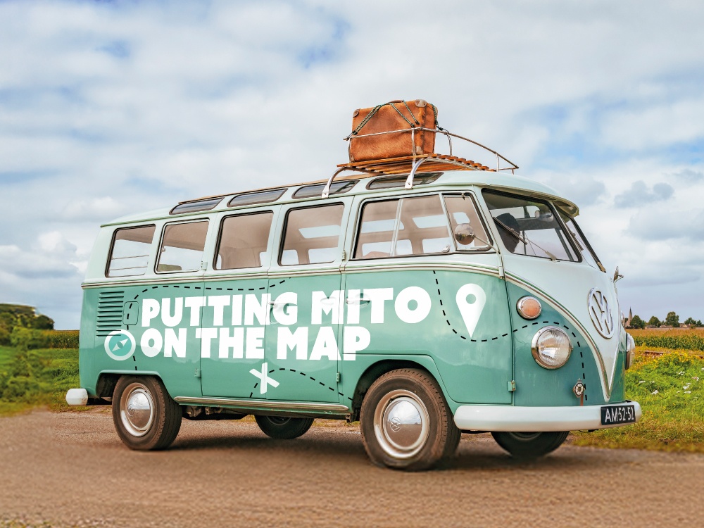 VW camper van with 'Putting mito on the map' logo on the side