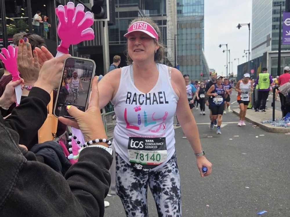 A Lily runner engaging with the cheer squad at the London Marathon