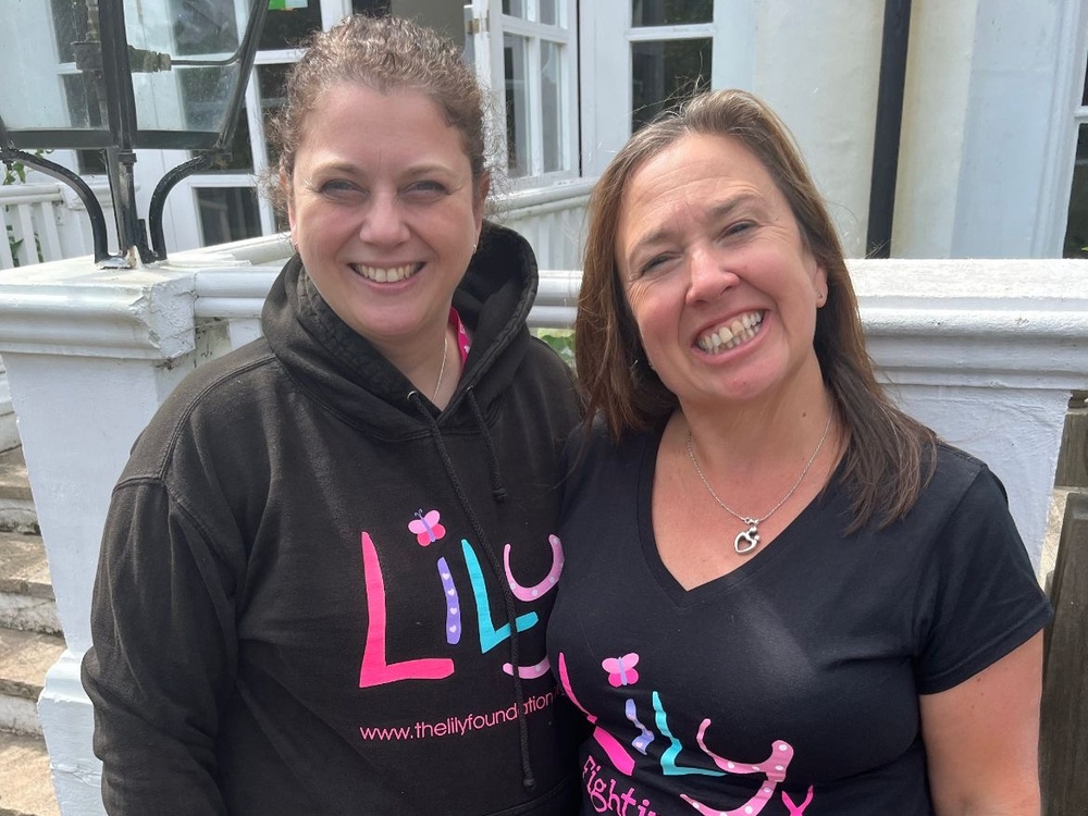 Two women in Lily branded clothing smiling for the camera in preparation for their London Marathon training