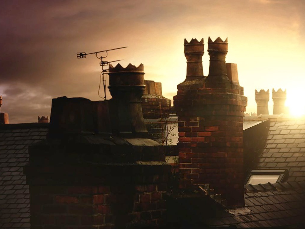 Chimney's on roof tops at dusk