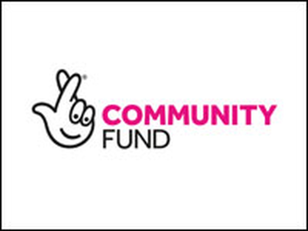 A drawing of a hand with crossed fingers and the words community fund