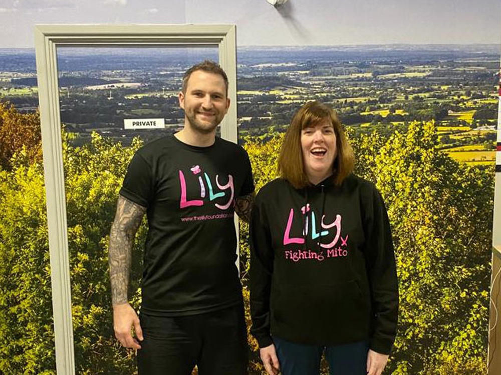 2 fundraisers in Lily branded Tshirts at the top of a hill about to start their training