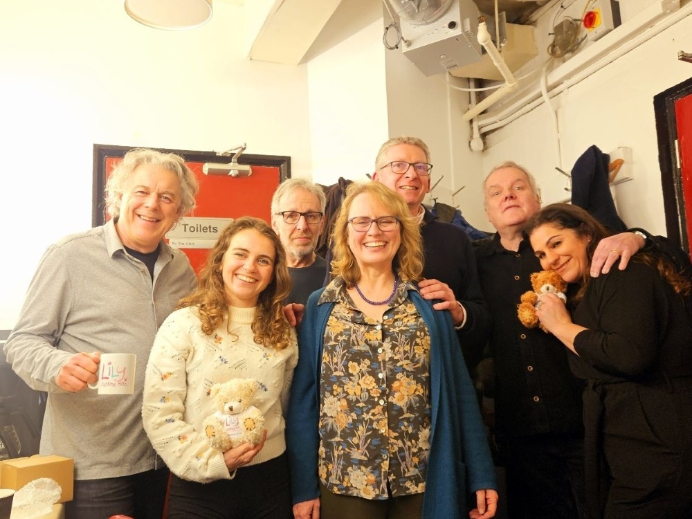 A group of comics with a mitochondrial disease patient at the Lily Comedy Night