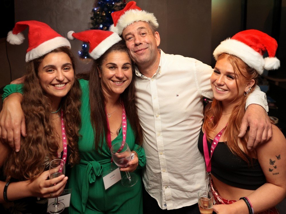 Lily founder Liz with her partner and two grown-up daughter all wearing Santa hats