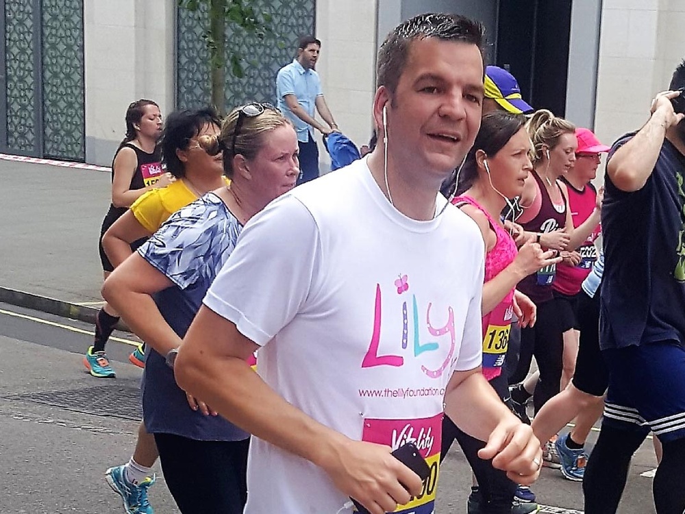A man running in a Lily Foundation running top