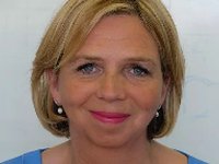 A lady with bobbed blonde hair smiling