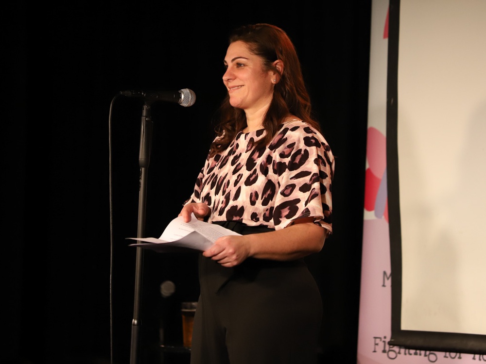 CEO Liz on stage at the Lily Comedy Night