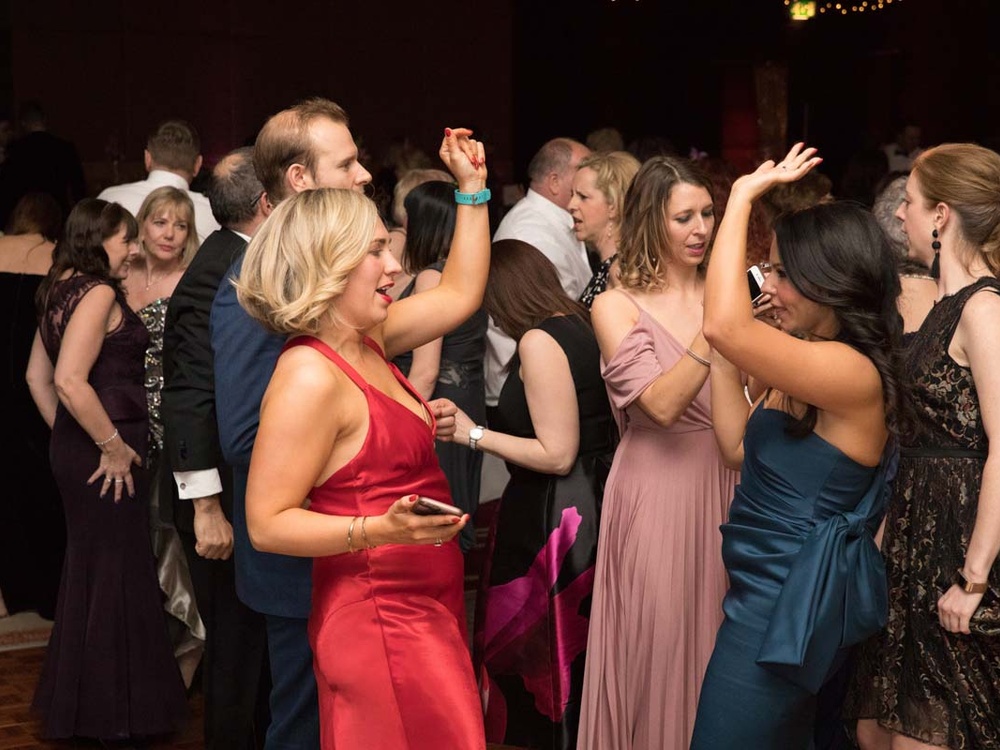 People in party clothes having fun on the dancefloor at the Lily ball