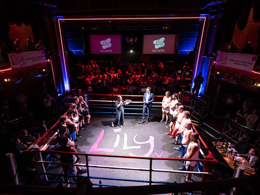 The boxing ring at the Lily fight night filled with boxers and Lily founder Liz
