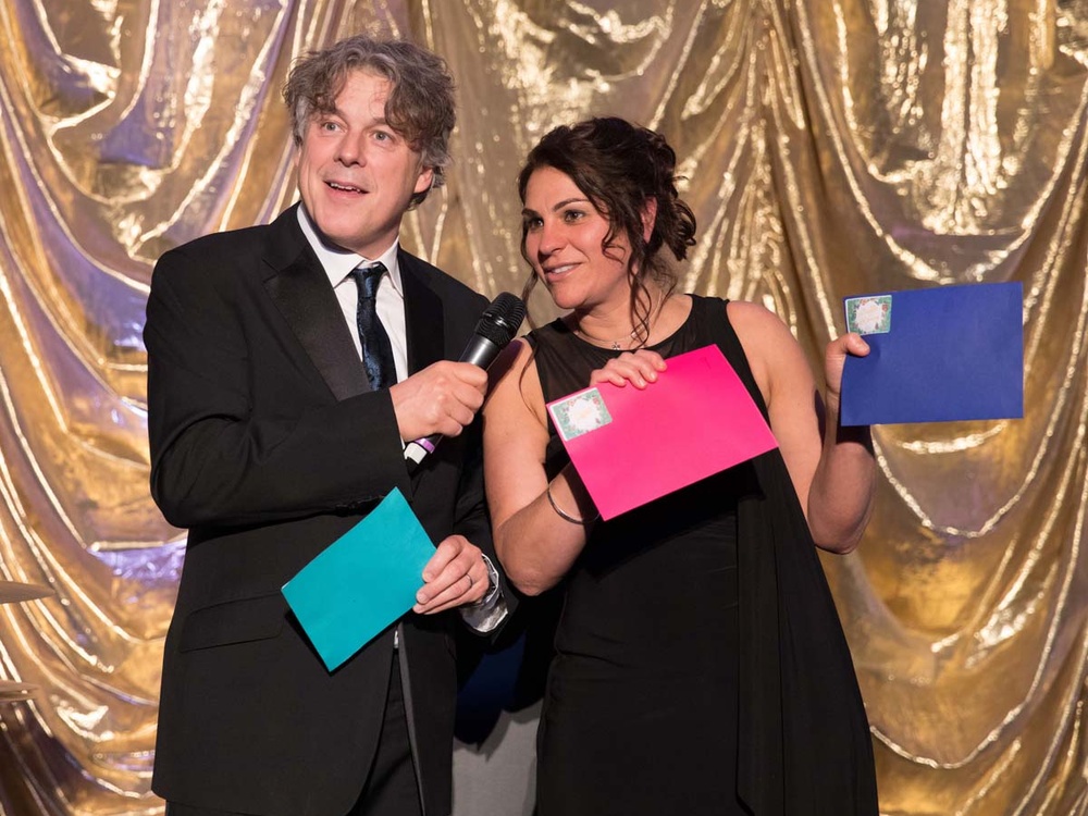 Comedian Alan Davies on stage with Lily CEO Liz