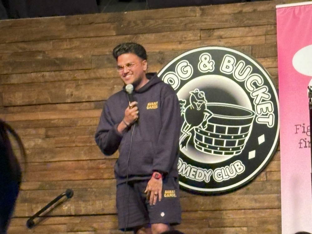 Faizan Shah on stage at the Frog and Bucket Comedy Club in Manchester