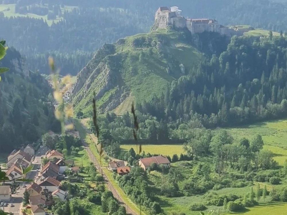 A sweeping view across the French countryside with a building up on a hill