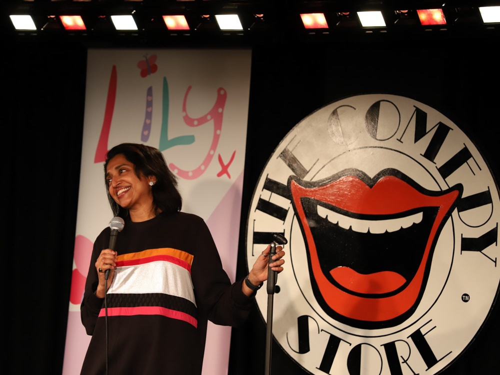 Comedian Sindhu Vee on stage at the Lily Comedy Night