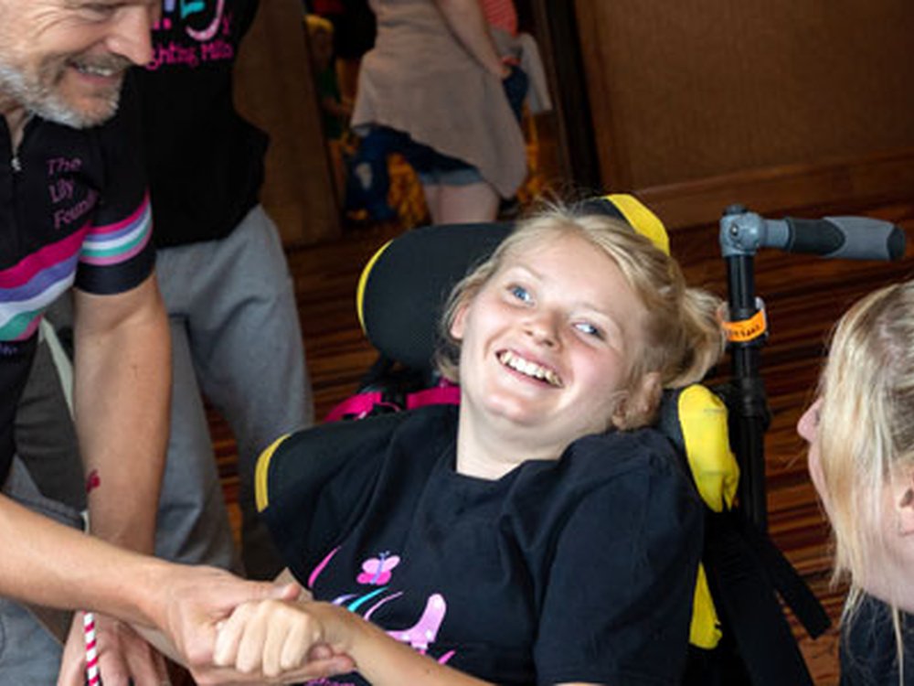 The more we invest, the closer we get to a cure - Young mito warrior in a wheelchair at the Lily Foundation family weekend talking to founder Liz