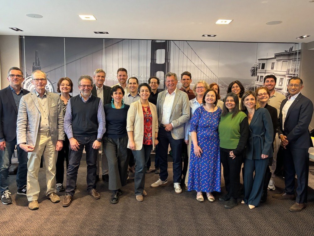 A group of people standing together at an international meeting to define primary mitochondrial disease